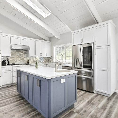 Kitchen with white cabinets and blue cabinets