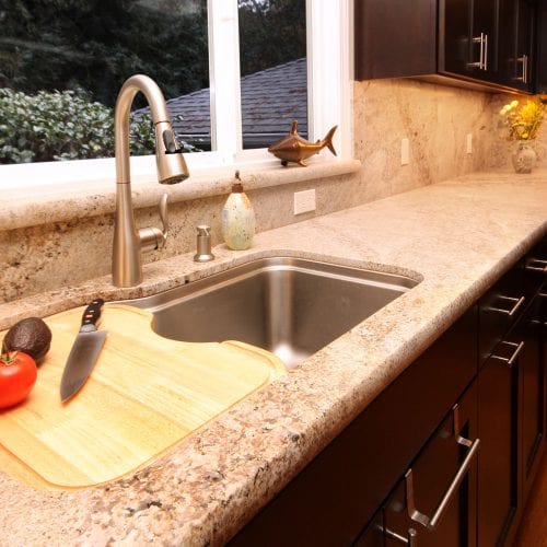 Granite countertop with stainless steel sink and cutting board