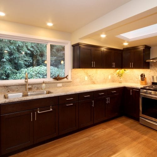 Row of wooden cabinets with granite countertop