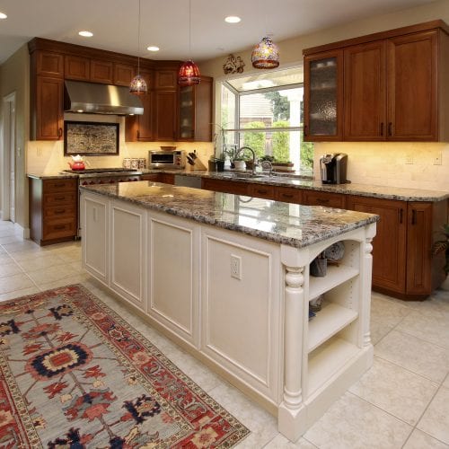 Kitchen with carpeted rug in front of island