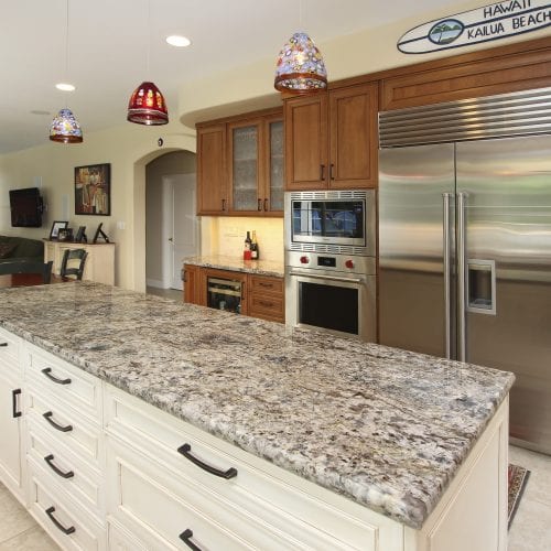 Granite countertop with hanging glass lamps above