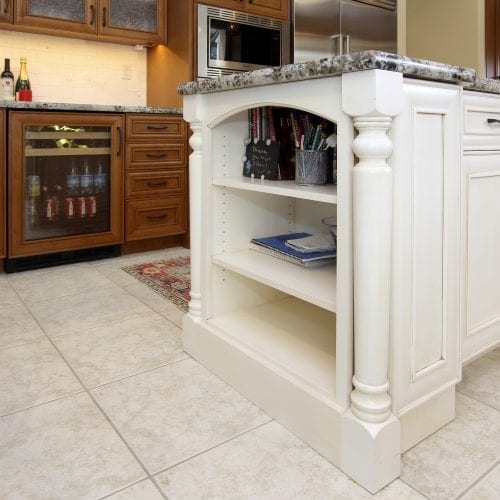 White wooden storage shelves on the end of the kitchen island