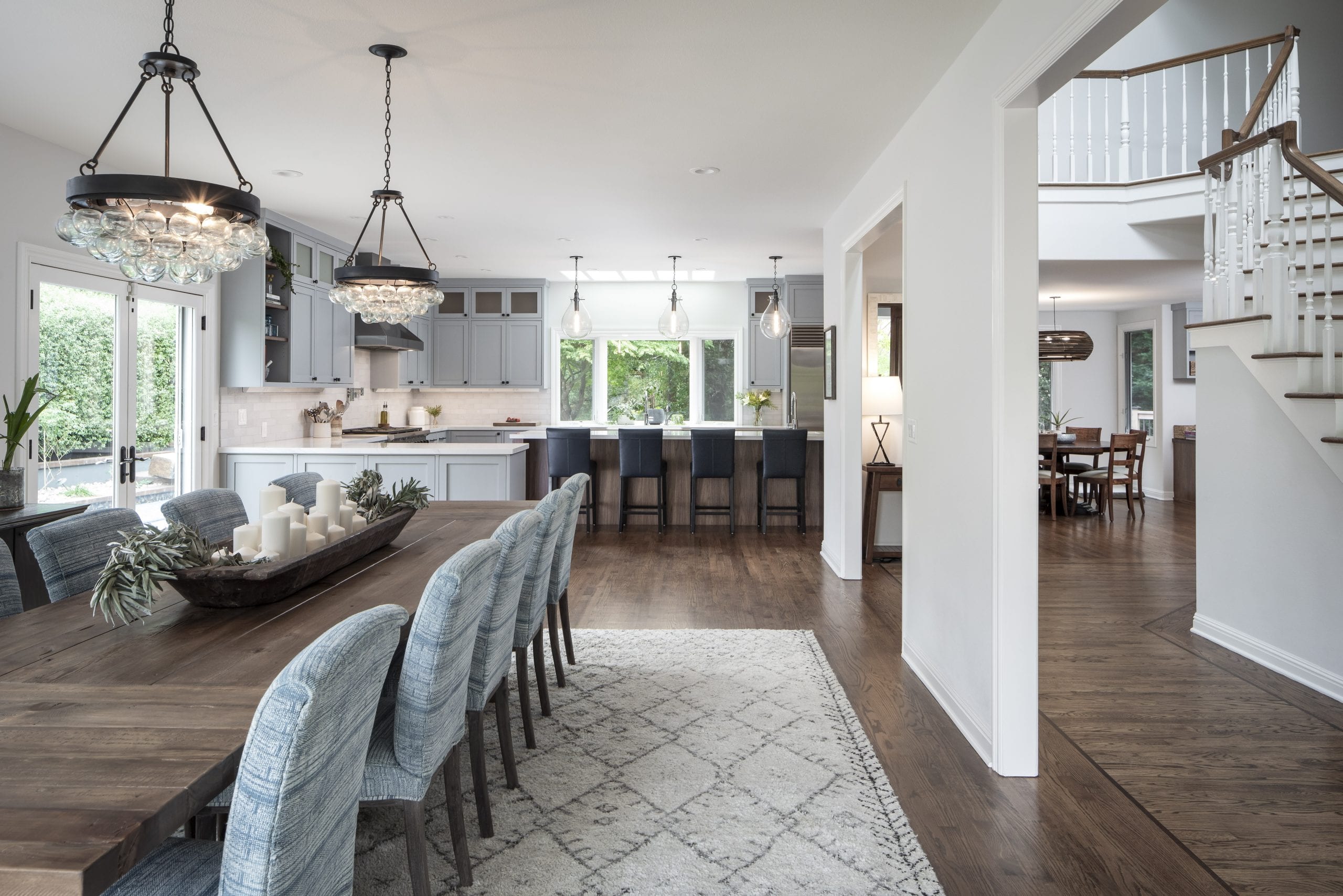 Dining room table with blue cloth high-back chairs