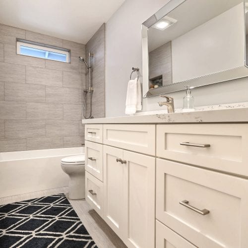 Black and white diamond pattern rug in front of counter