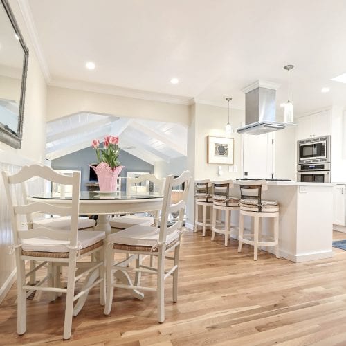 White dining room table with white wooden chairs