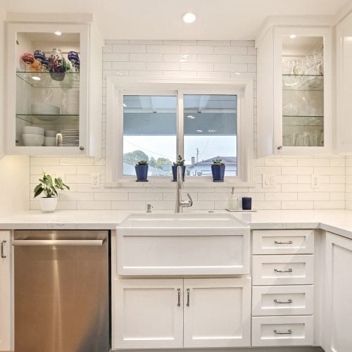 Kitchen sink embedded into white marble countertop