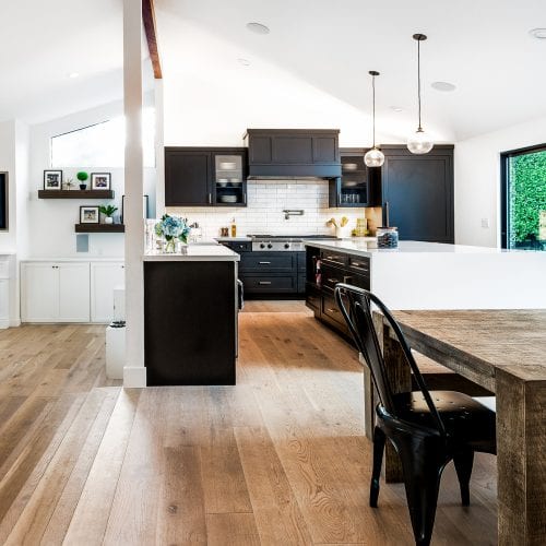 Open floor plan kitchen, dining room, and living room with hardwood flooring