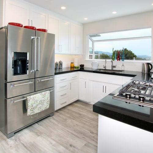 Kitchen with stainless steel appliances and white cabinets