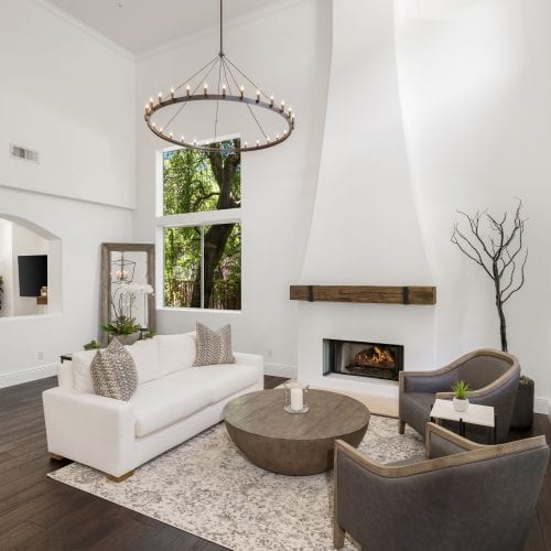 White fireplace with wooden mantle