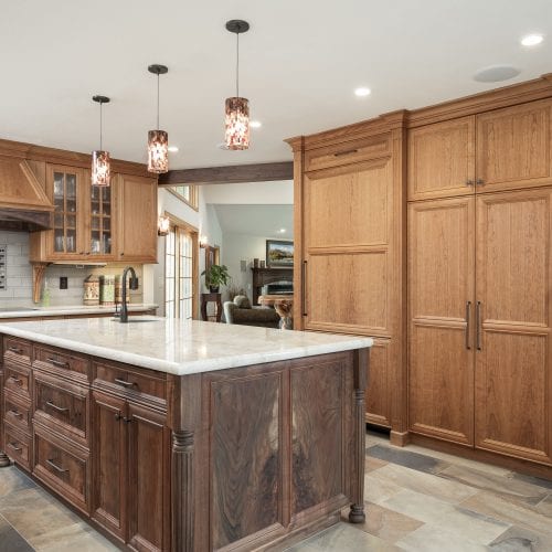 Wooden cabinets behind rustic wood island