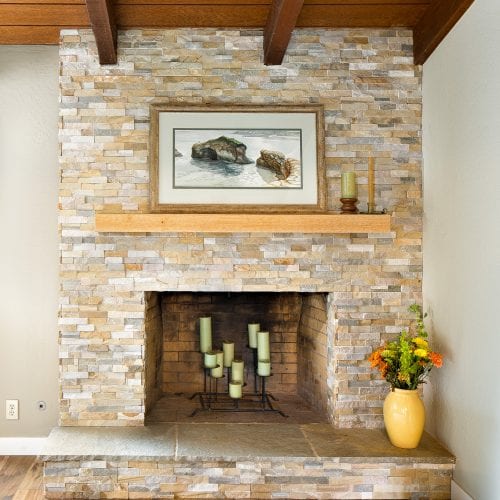 Limestone fireplace with wooden mantle