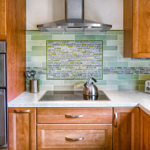 Green and Aqua tile backsplash above electric stove