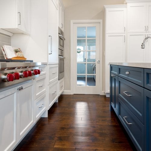 Blue cabinets with white marble countertop on top