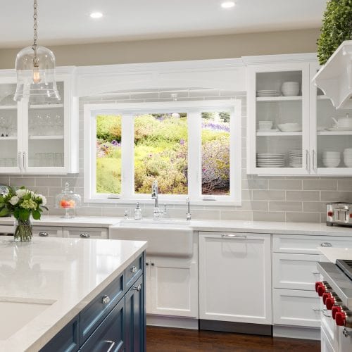 Kitchen with white wooden cabinets