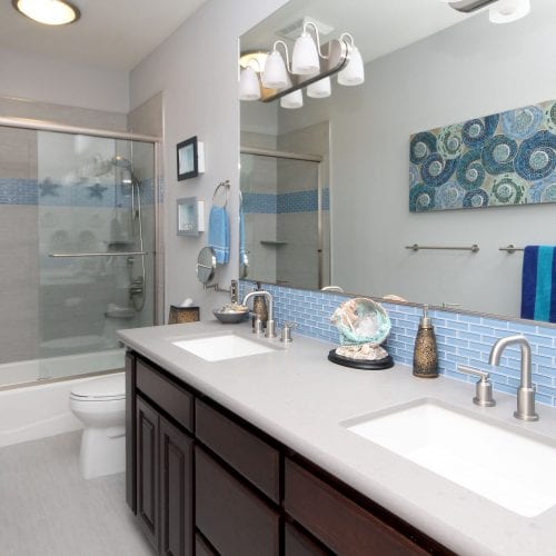 Light blue bathroom with stainless steel fixtures