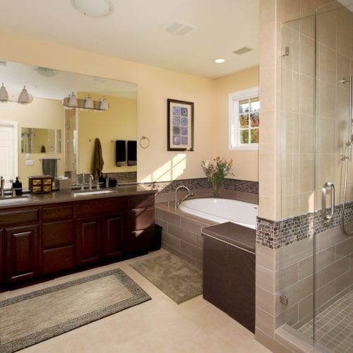 Bathroom with light tile floor and contrasting cabinets