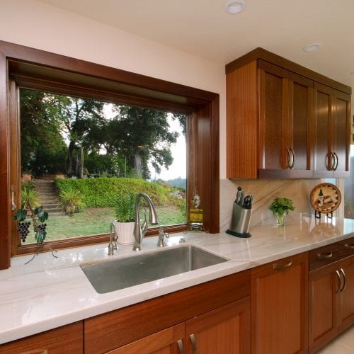 Kitchen sink in front of window overlooking trees