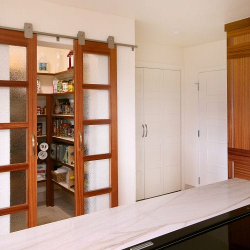 Kitchen pantry with sliding wooden doors