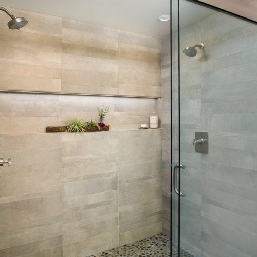 Glass shower with stone tile interior