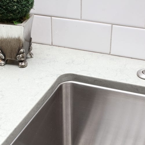 Kitchen sink corner showing a flush seam between countertop and sink base