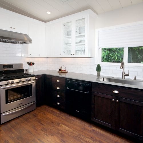 Kitchen remodel featuring a white and black contrast between floor and ceiling cabinets