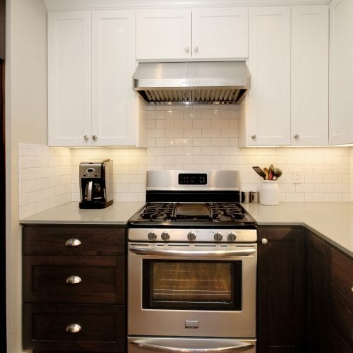 Kitchen countertop with stainless steel stove and contrasting modern color scheme