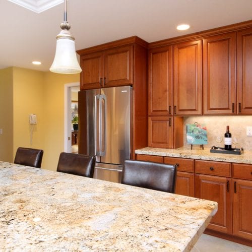 Kitchen island with granite countertop and hanging ceiling lights