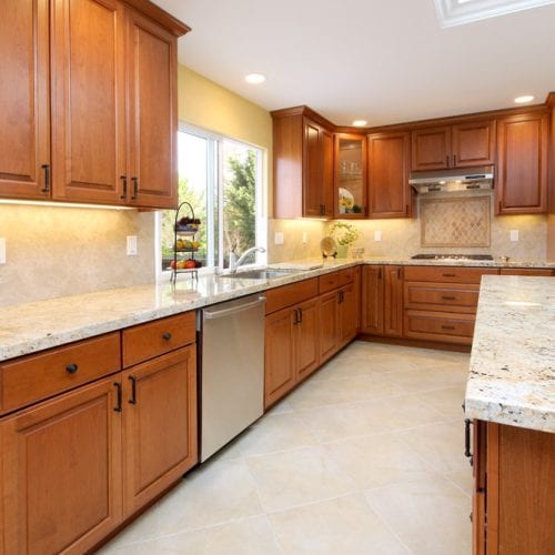 Kitchen remodel with wooden cabinets and a stainless steel dishwasher