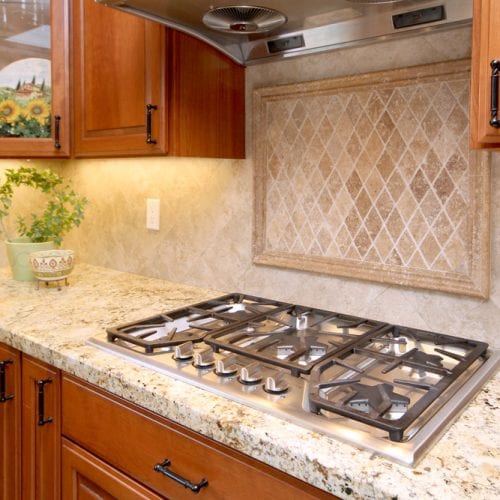 Multi-burner stove top with wooden cabinetry surrounding