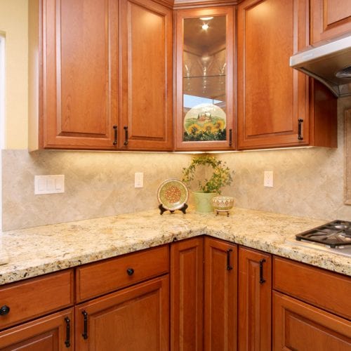 Kitchen corner with granite countertop and wood cabinets