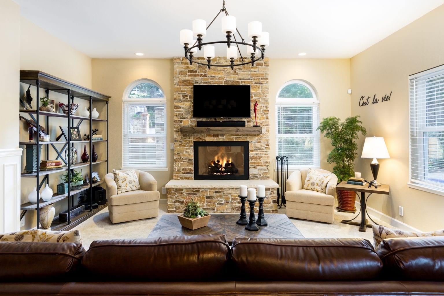 Living space with TV mounted to stone fireplace