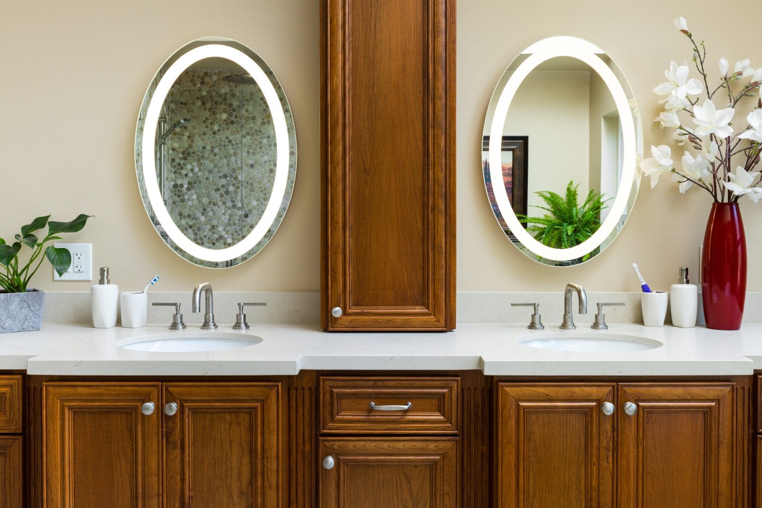 Bathroom with two oval mirrors with built-in lighting