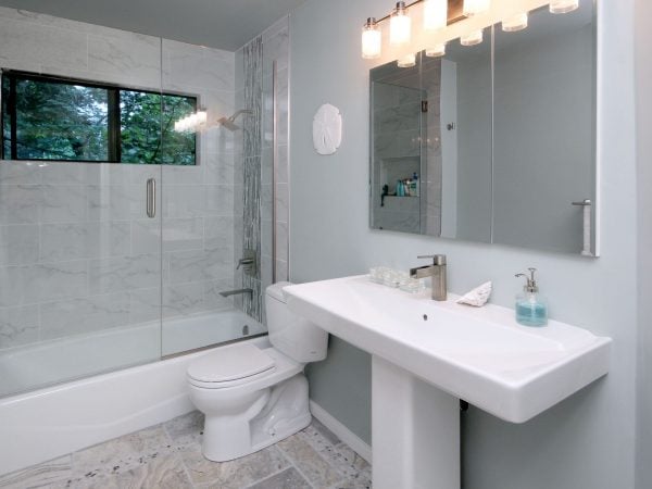 Bathroom featuring white tones and a sliding glass door