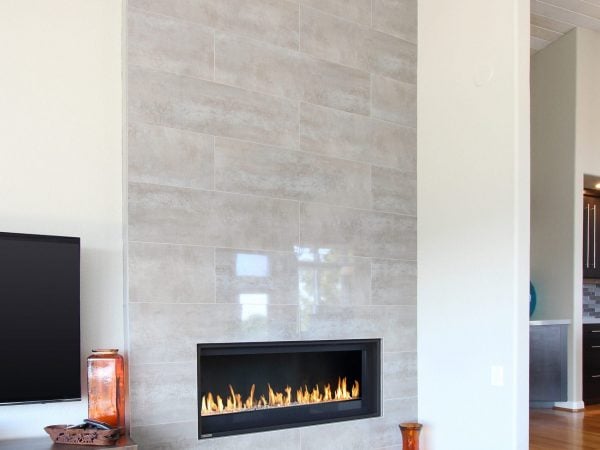 Living room fireplace with polished granite lining the wall