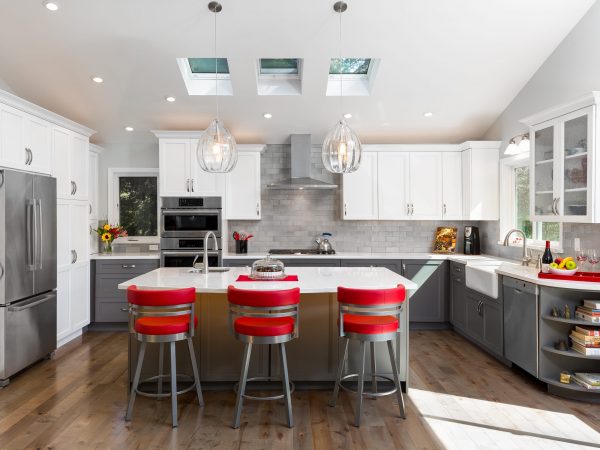 Elegant kitchen with white cabinets and red barstools