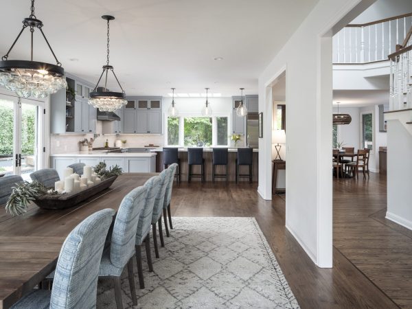 Kitchen and dining room that features white & blue colors and a candle center piece