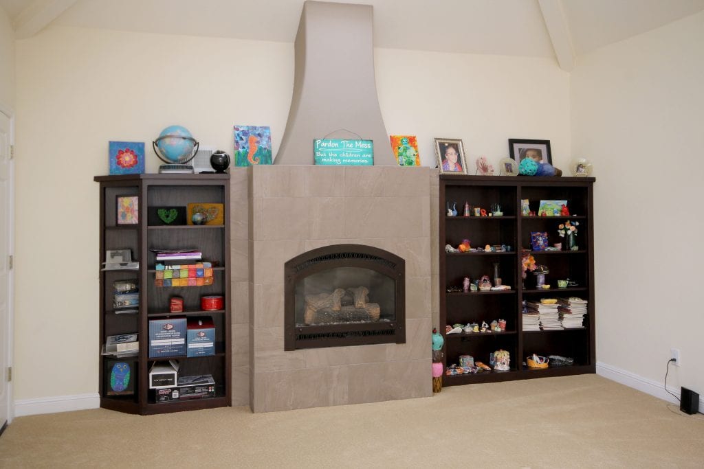 Built-in fireplace and surrounded by 2 black shelves