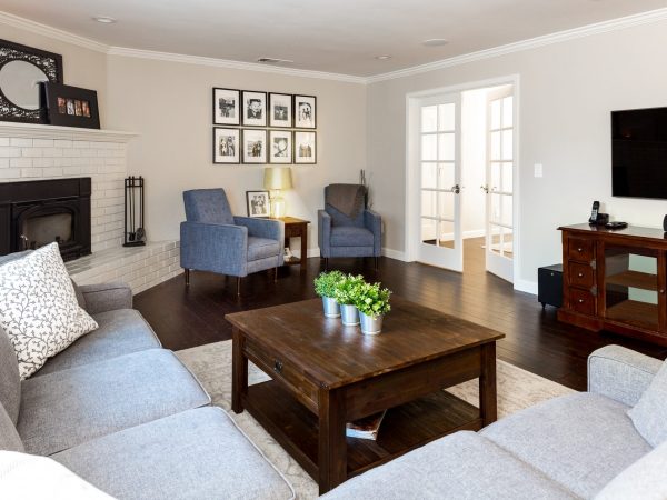 Living room with L-shaped sofa, wooden coffee table and two blue chairs