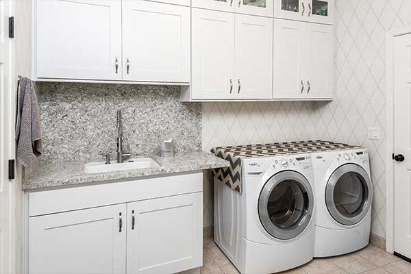 Laundry room with white cabinets and a washer & dryer combo