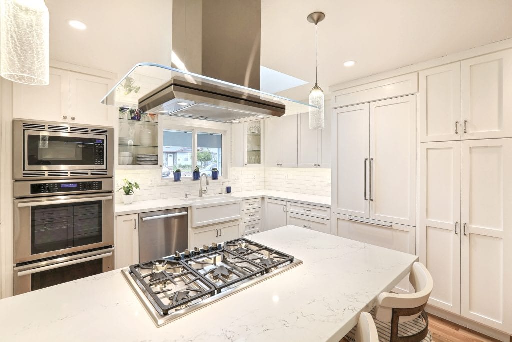 Kitchen with stainless steel overhead exhaust fan