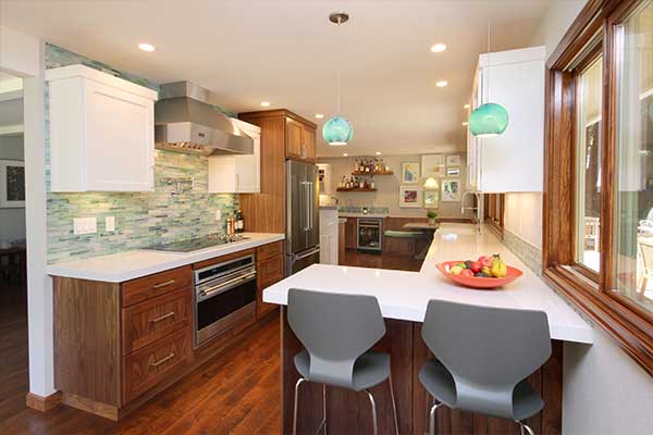 Elegant kitchen with wooden finished cabinets and flooring with white countertops