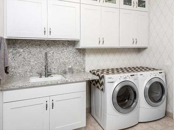 Laundry room with white cabinets and washer & dryer combo