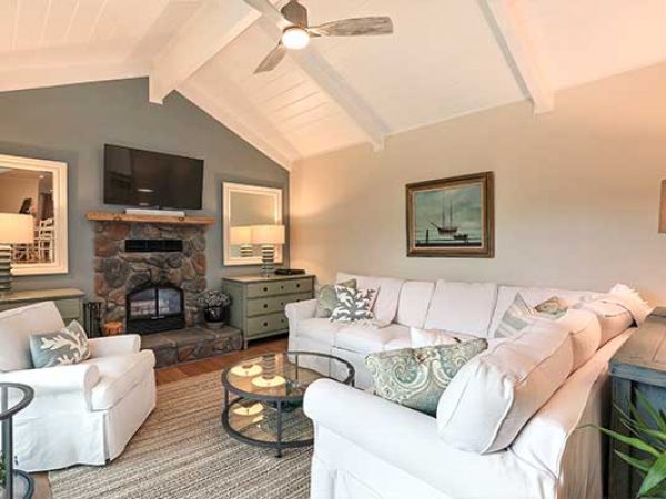 Living room with white furniture and cathedral style ceiling