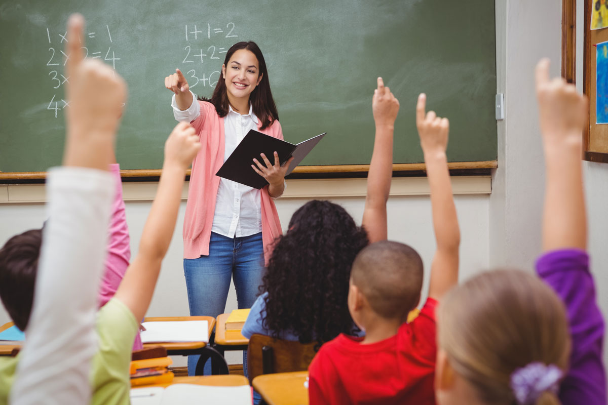 Teacher calls on students who have their hands raised